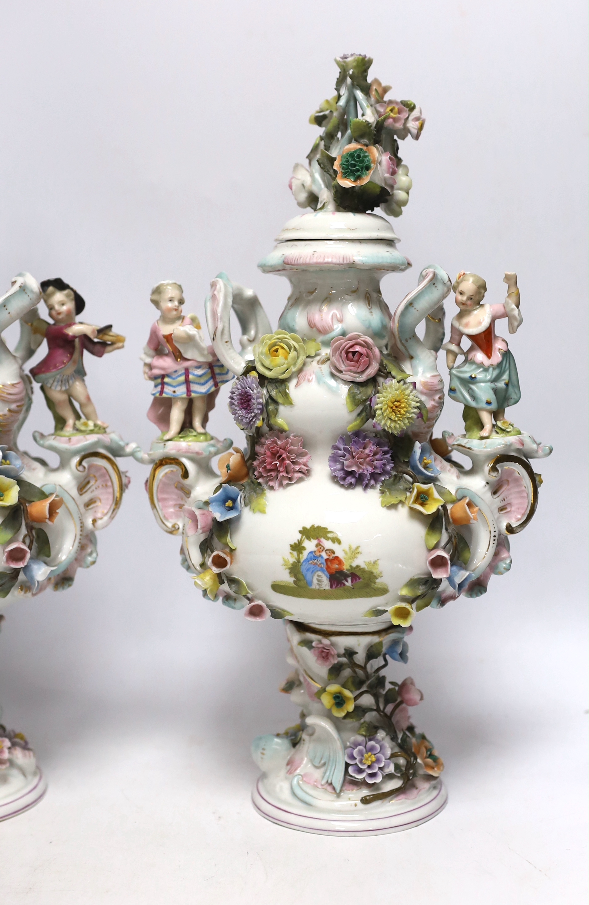 A pair of Sitzendorf floral encrusted and figural vases and covers, late 19th century, 36cm high